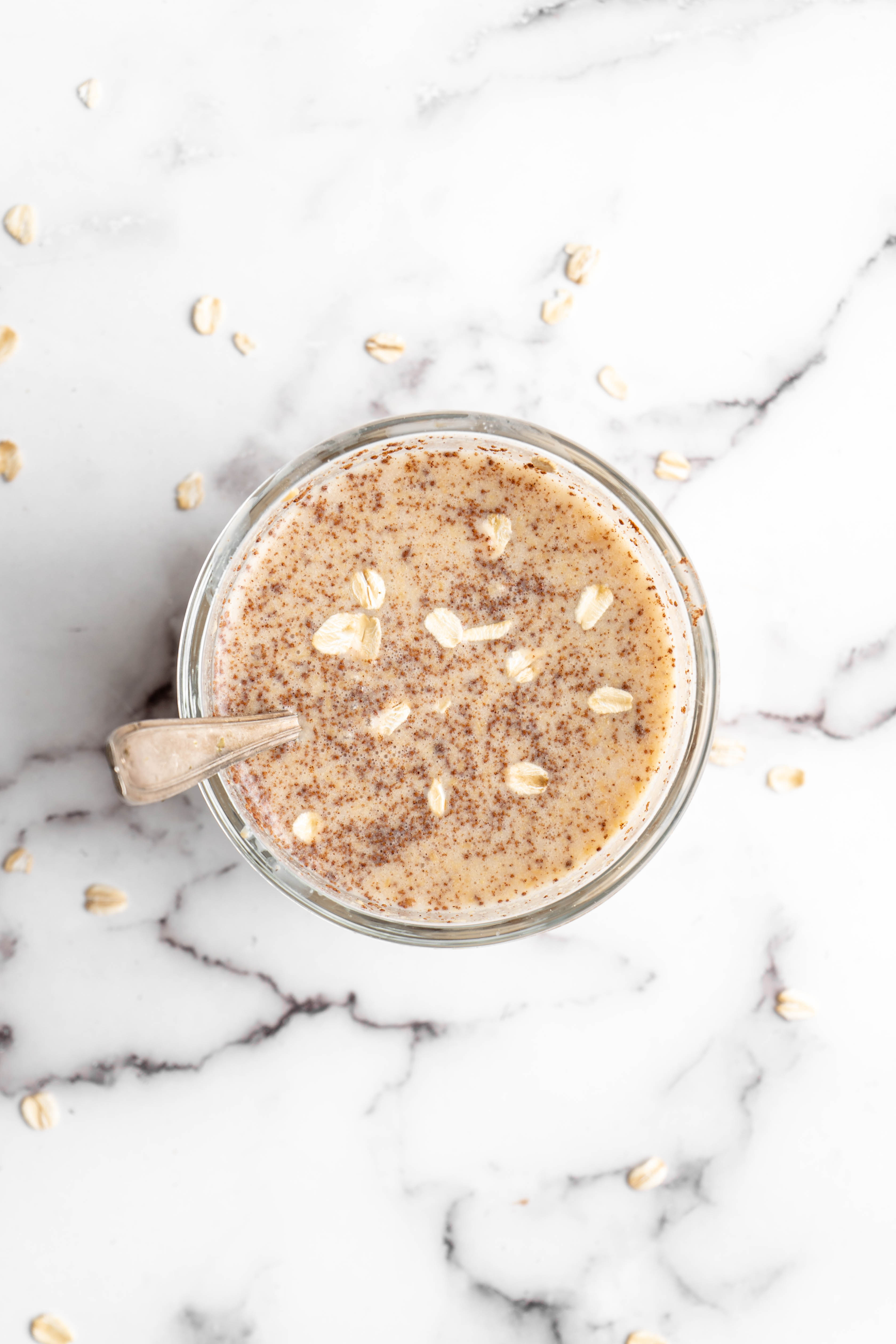 Overhead view of overnight oats in jar with spoon