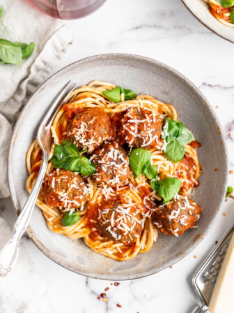 Overhead view of vegan spaghetti and meatballs on plate with fork
