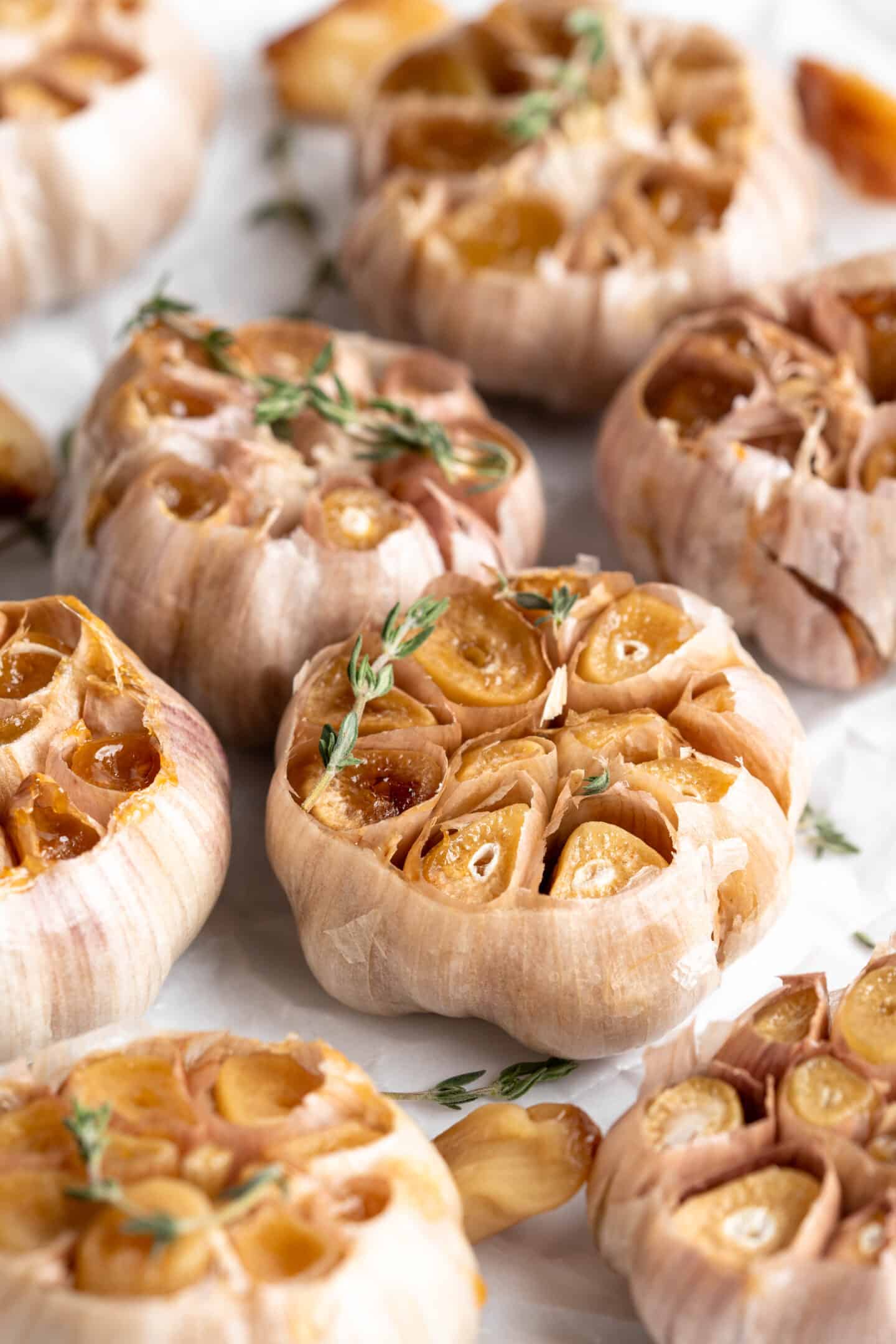 Roasted garlic heads with sprigs of thyme