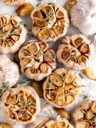 Air fryer roasted garlic garnished with sprigs of thyme