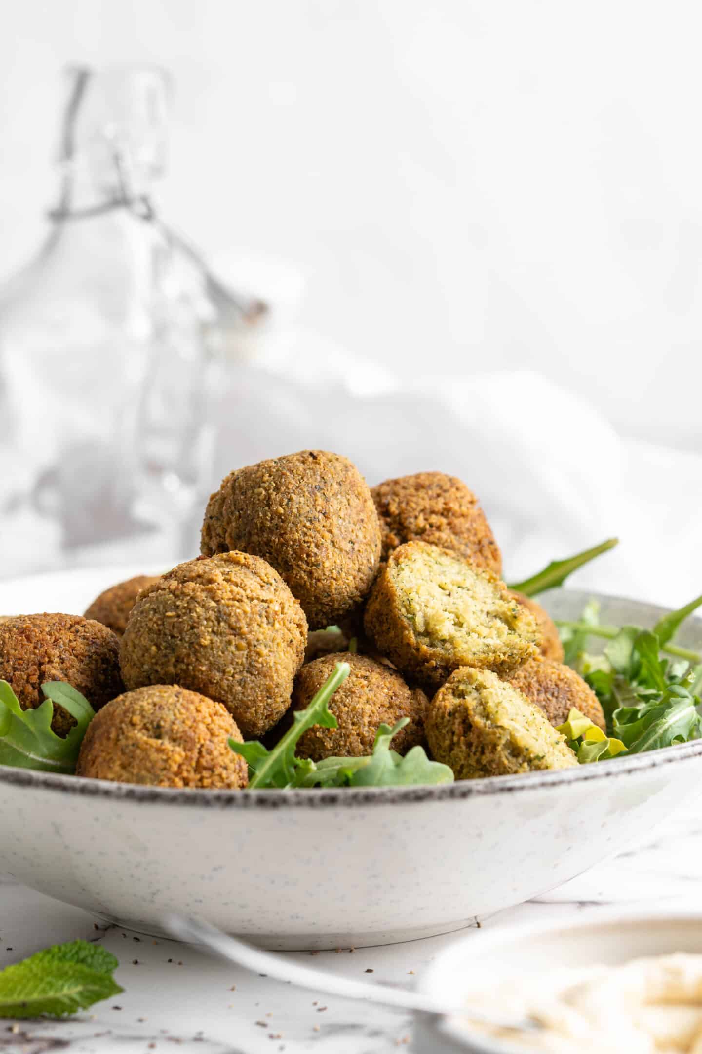 Bowl of greens topped with homemade falafel