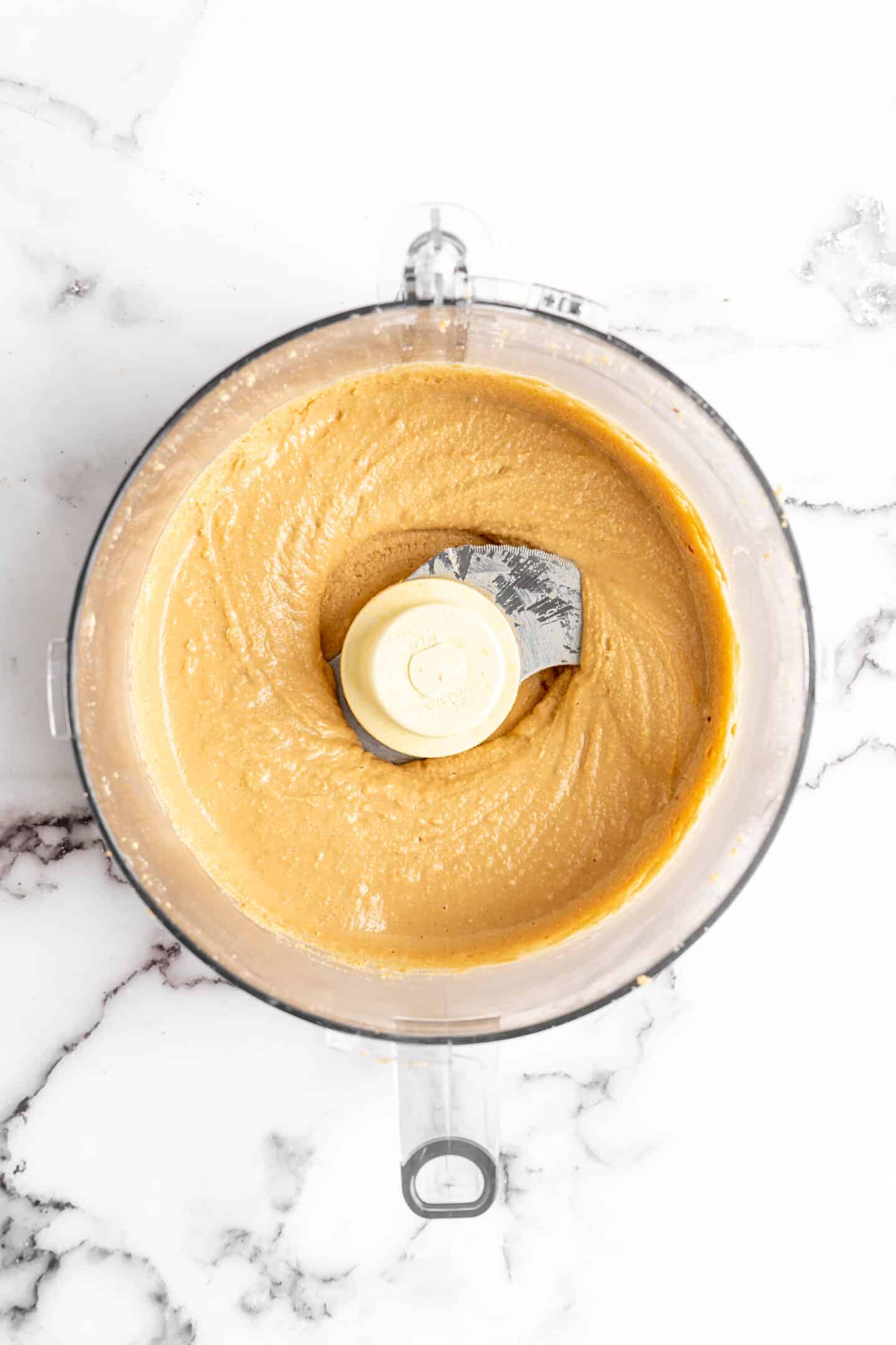 Overhead view of homemade peanut butter in food processor