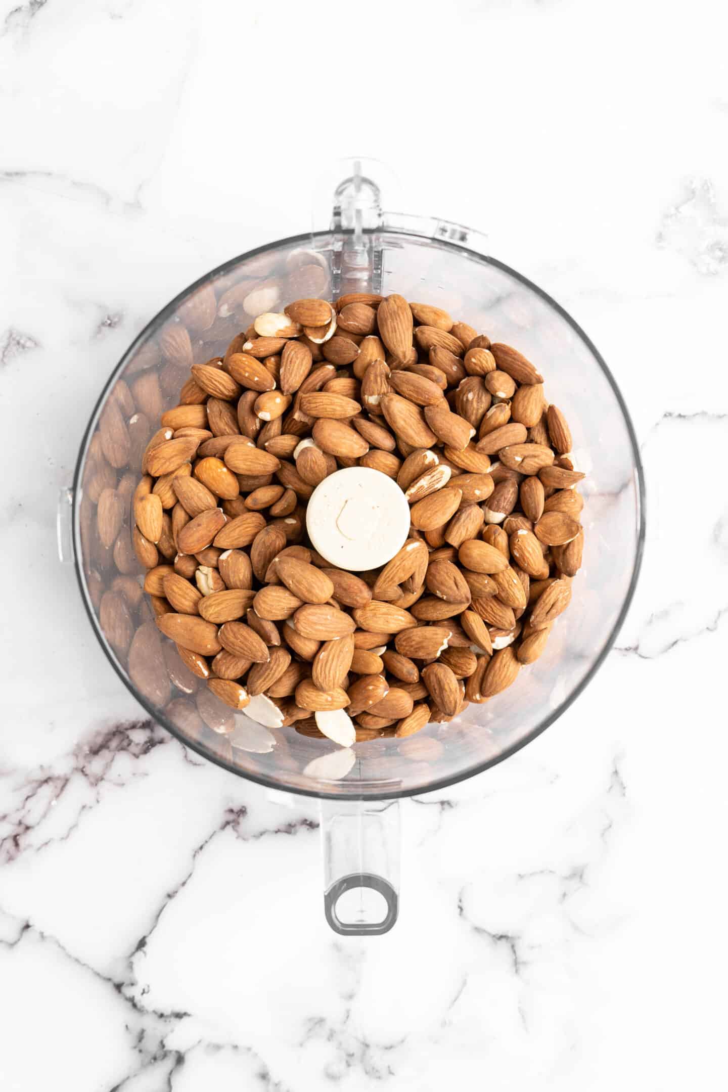 Overhead view of almonds in food processor