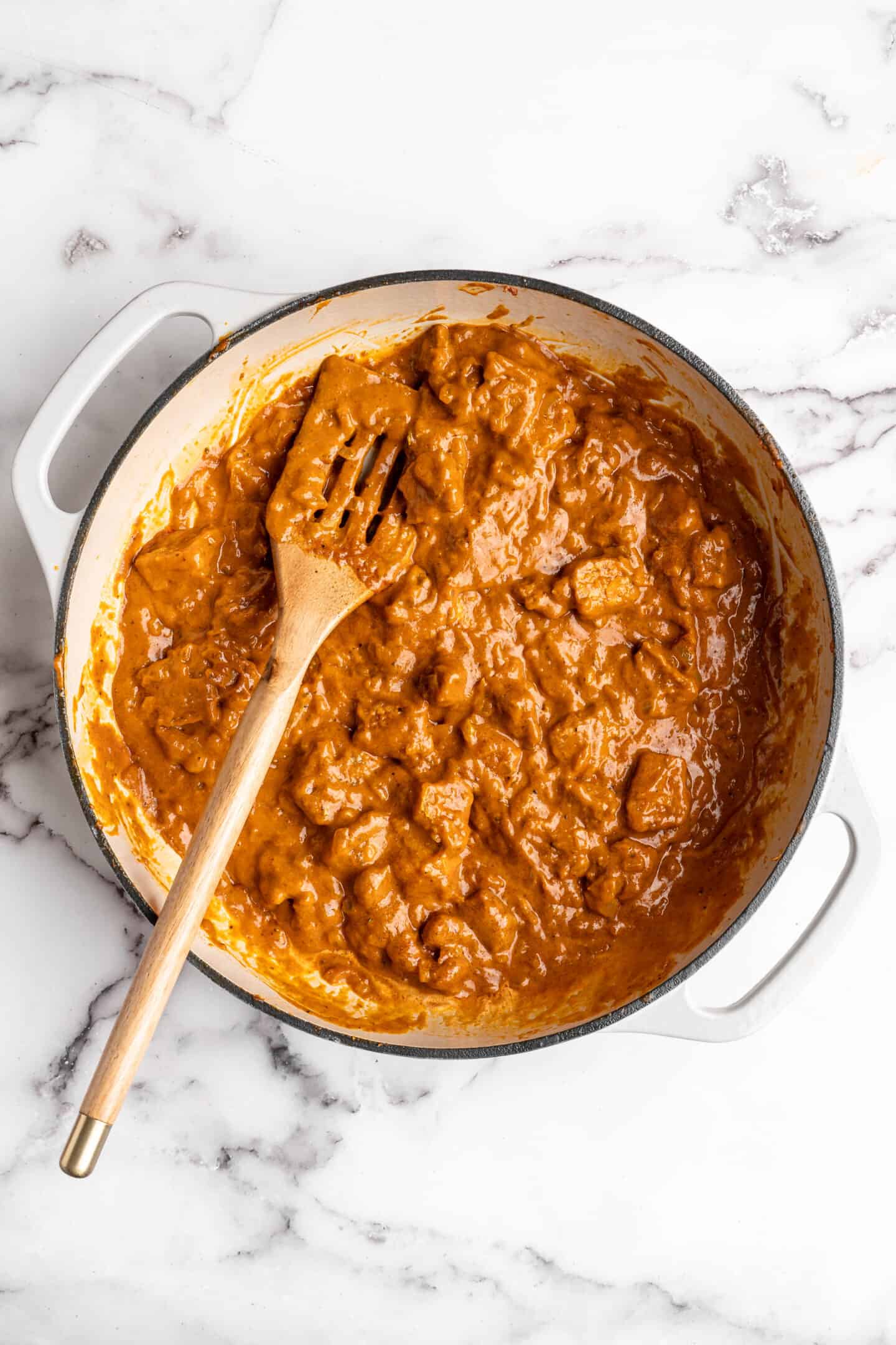 Overhead view of vegan butter chicken in Dutch oven