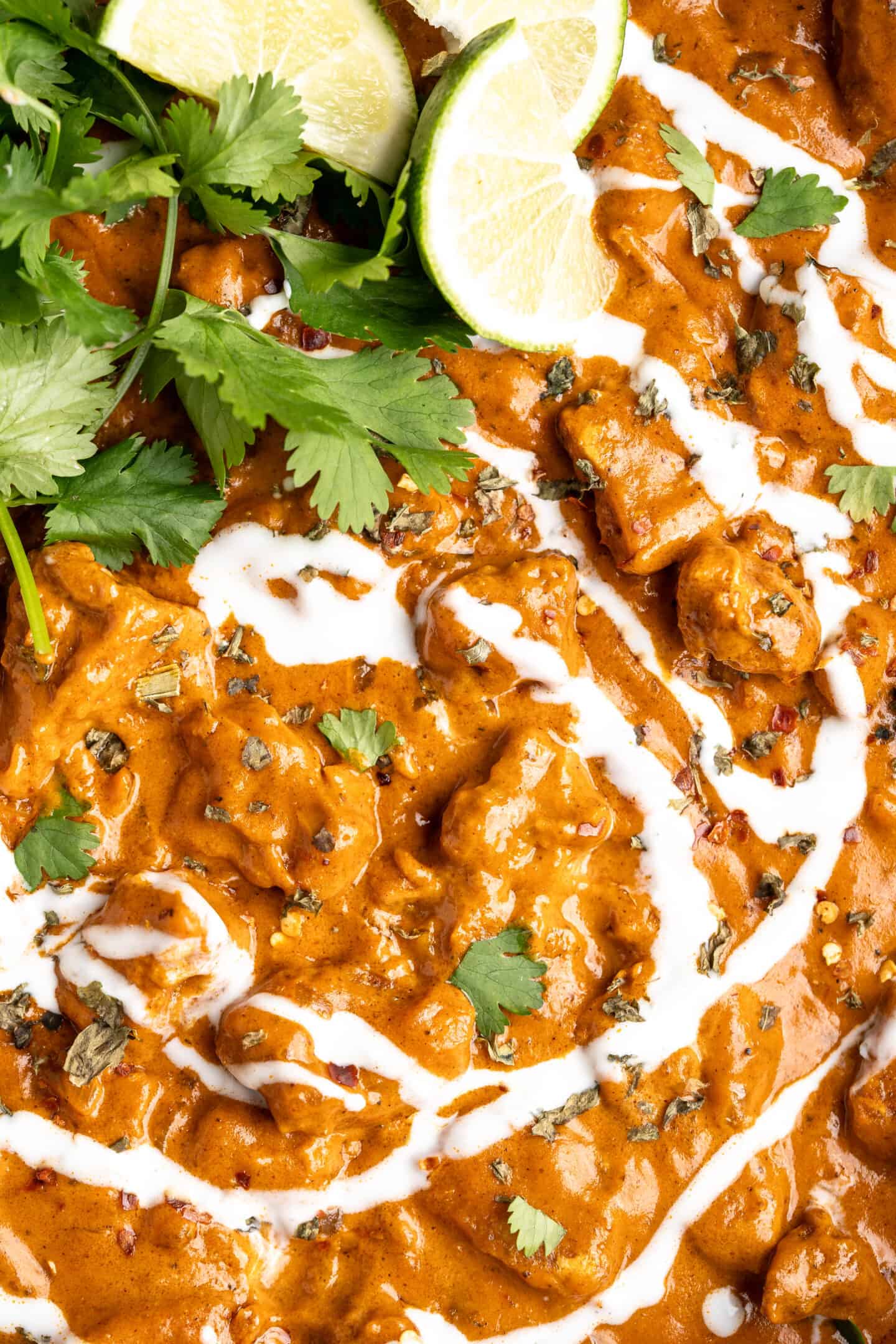 Closeup of vegan butter chicken with garnishes