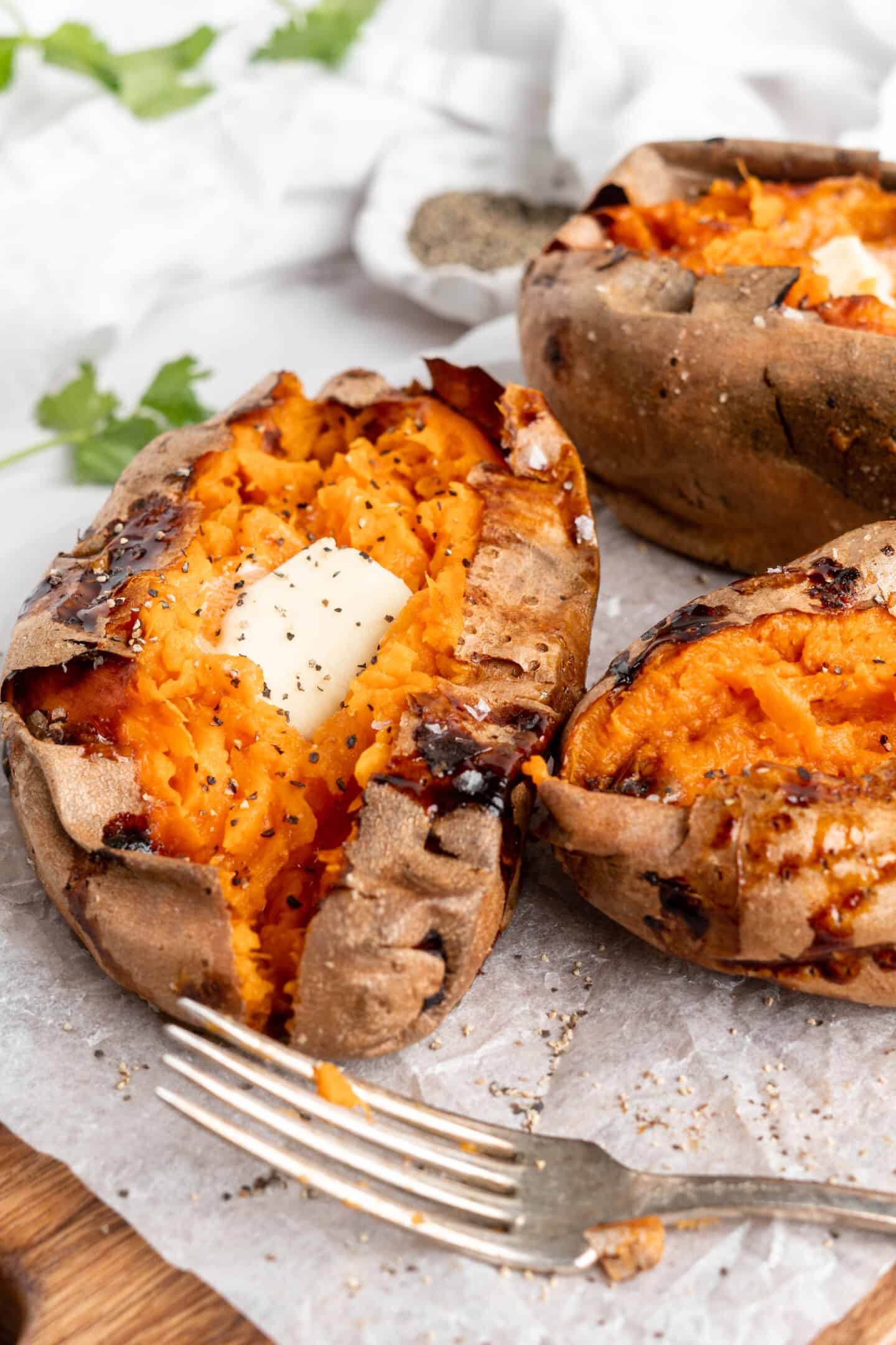 Air fryer sweet potatoes topped with butter