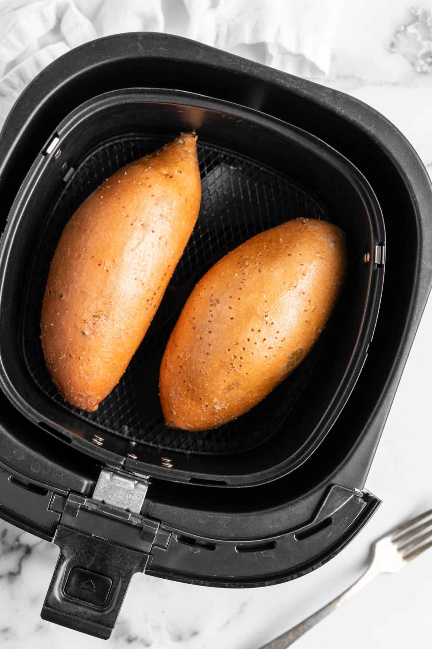 Two sweet potatoes in air fryer