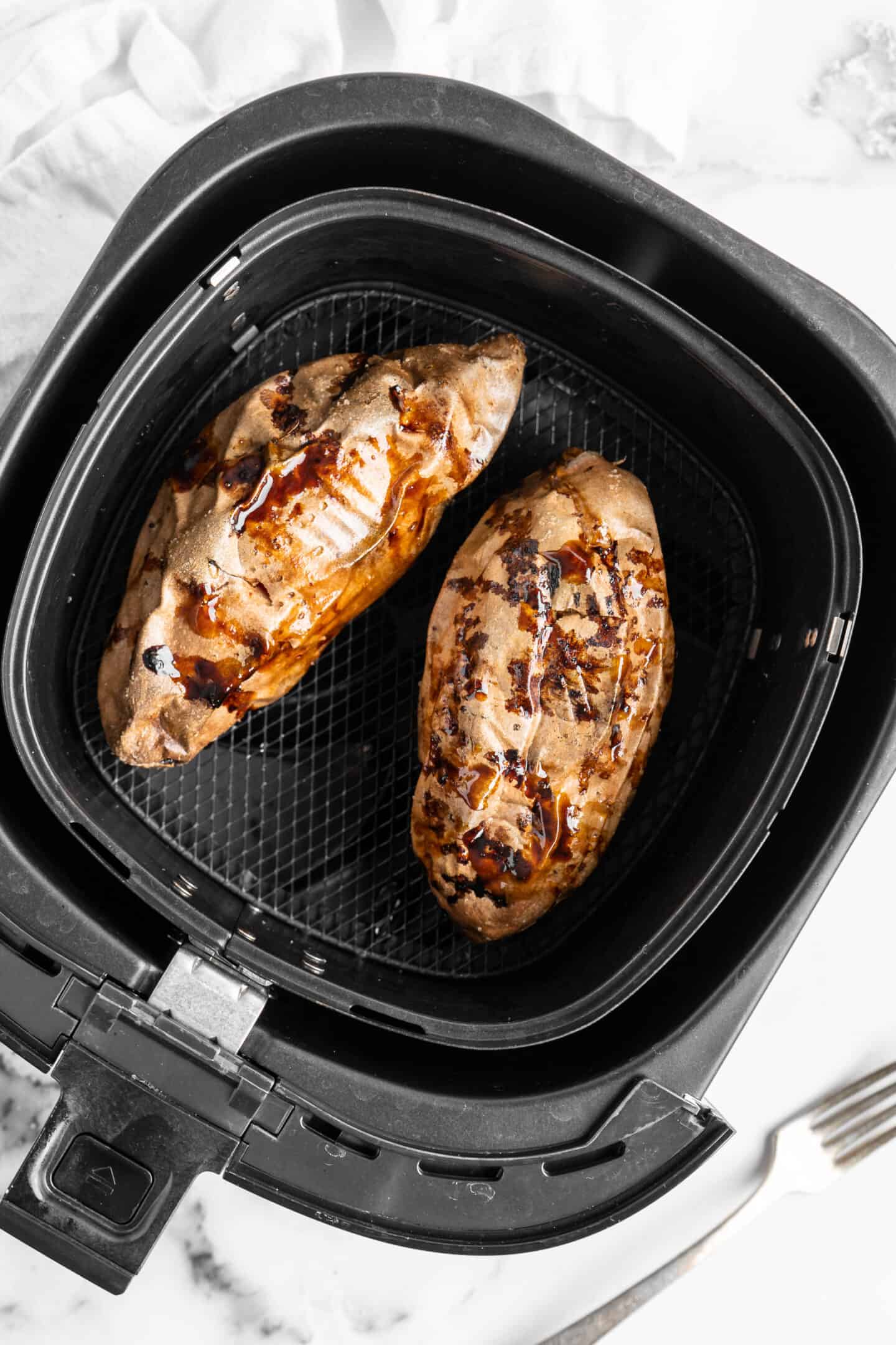 Two baked sweet potatoes in air fryer