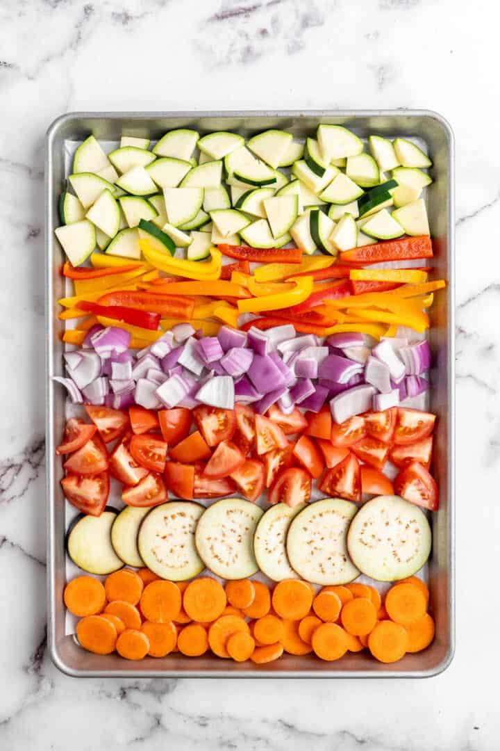 Rainbow of raw vegetables arranged on sheet pan