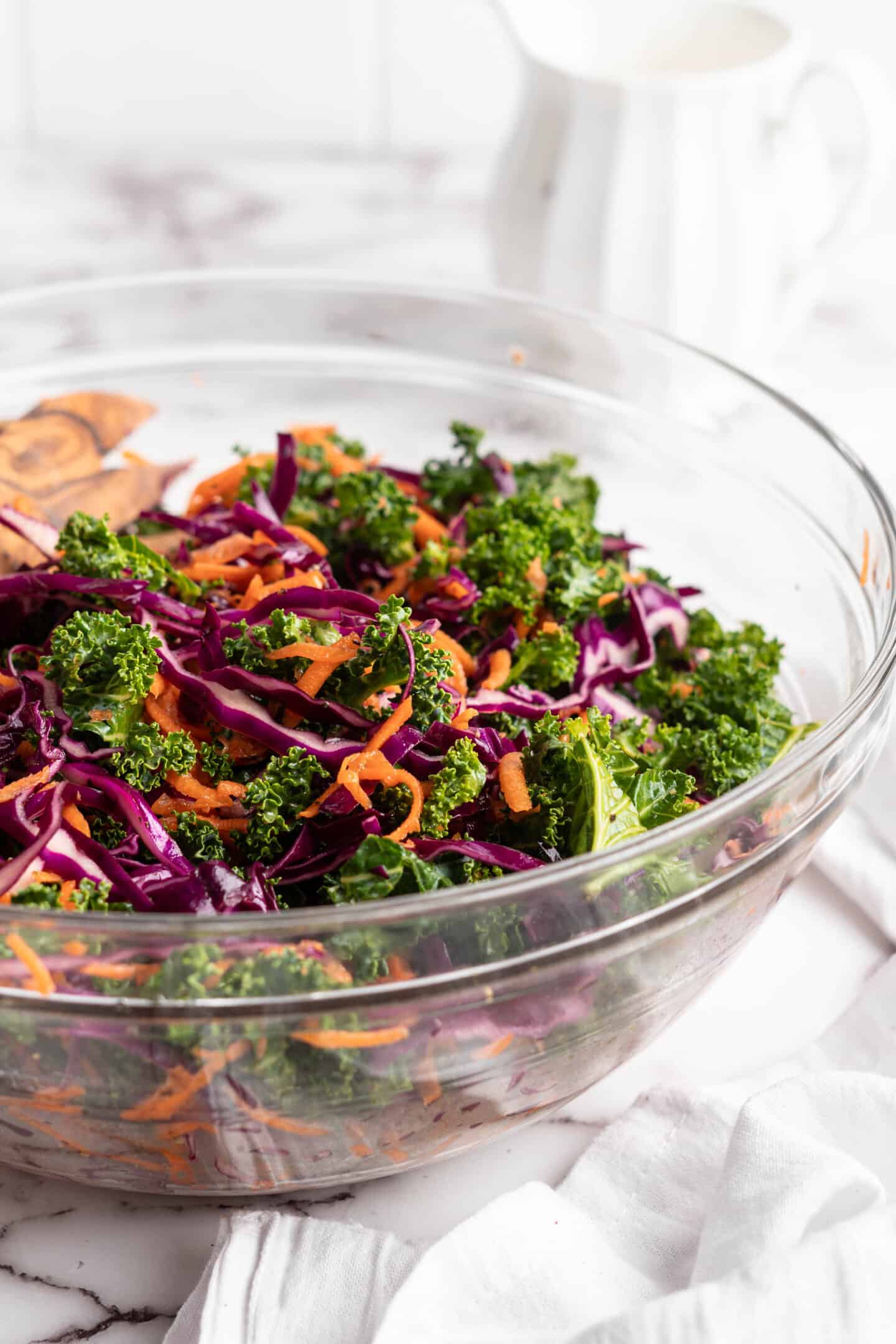 Kale slaw in large glass bowl.