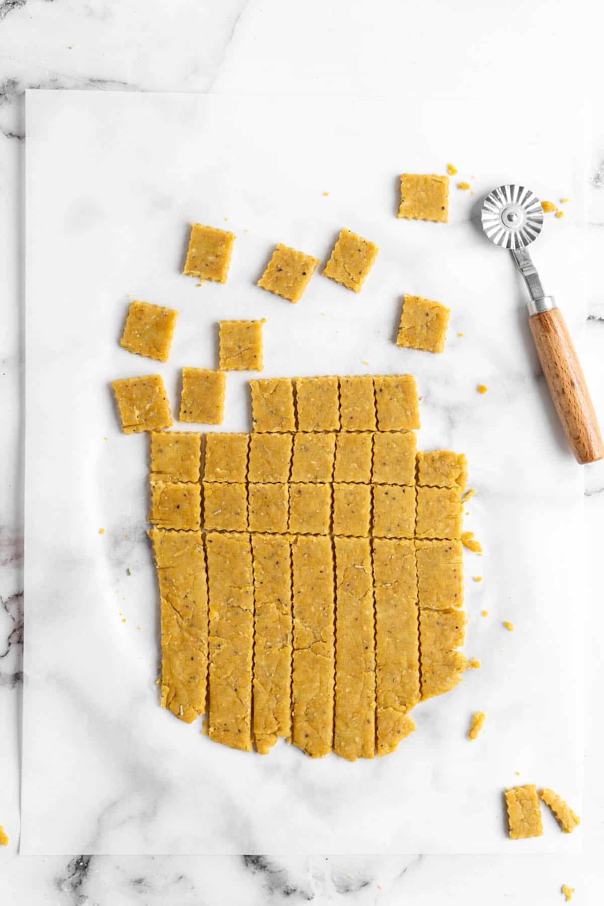 Overhead view showing vegan cheese crackers being cut