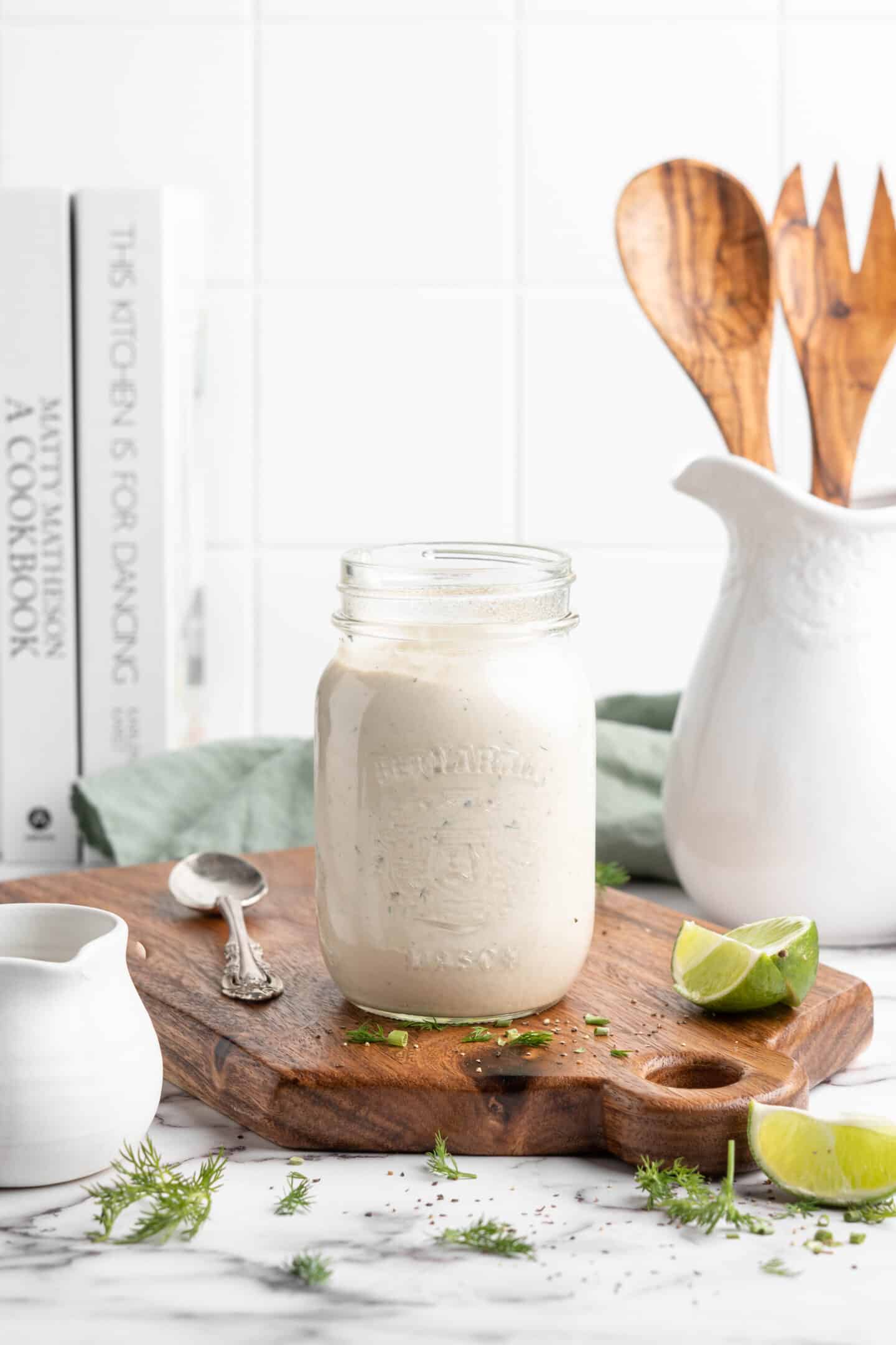 Jar of vegan ranch dressing on wood board