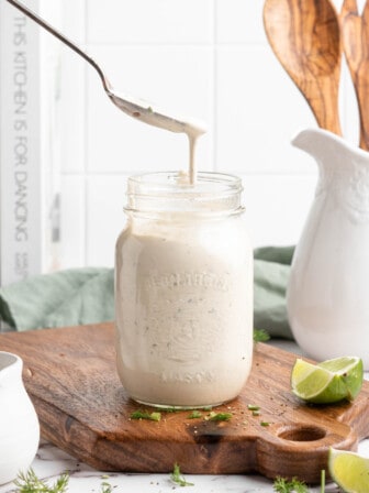 Spoon drizzling vegan ranch dressing into jar