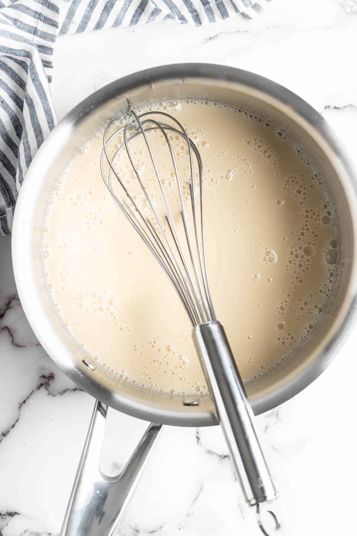 Vegan condensed milk in pan with whisk