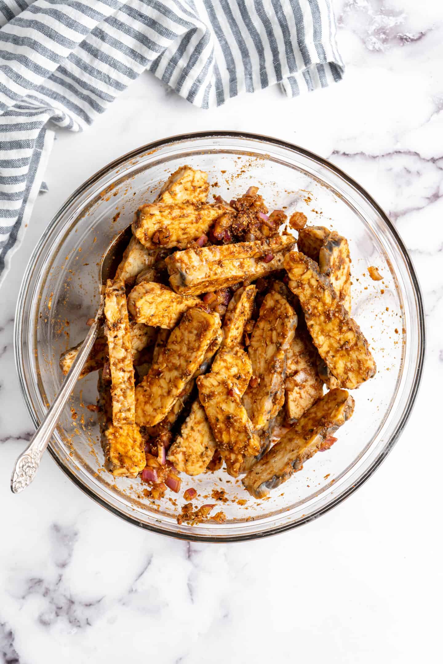 Bowl of tempeh tossed in marinade