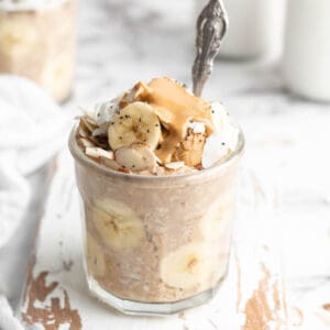 Peanut butter banana overnight oats in jar with spoon