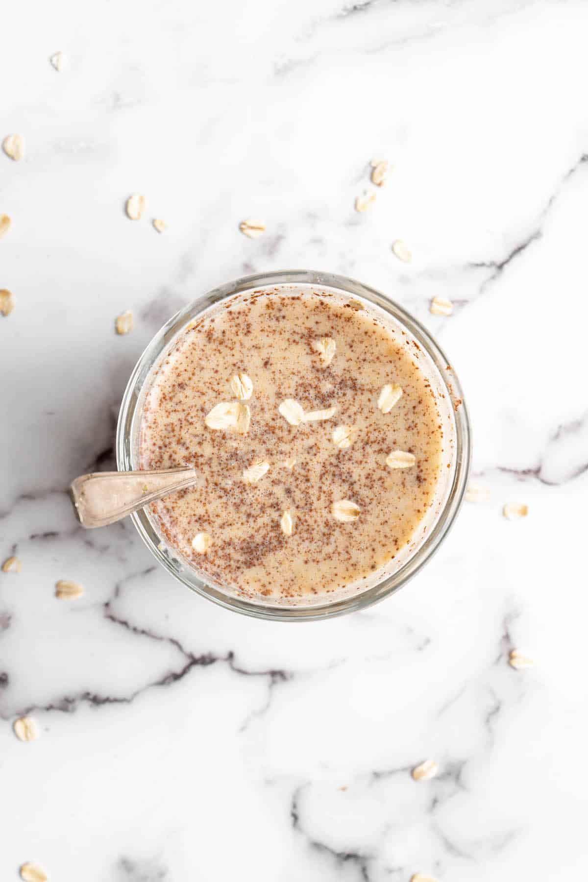 Overhead view of overnight oats in jar with spoon