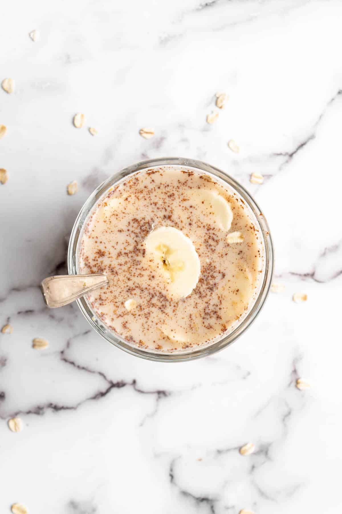 Overhead view of overnight oats in jar with spoon