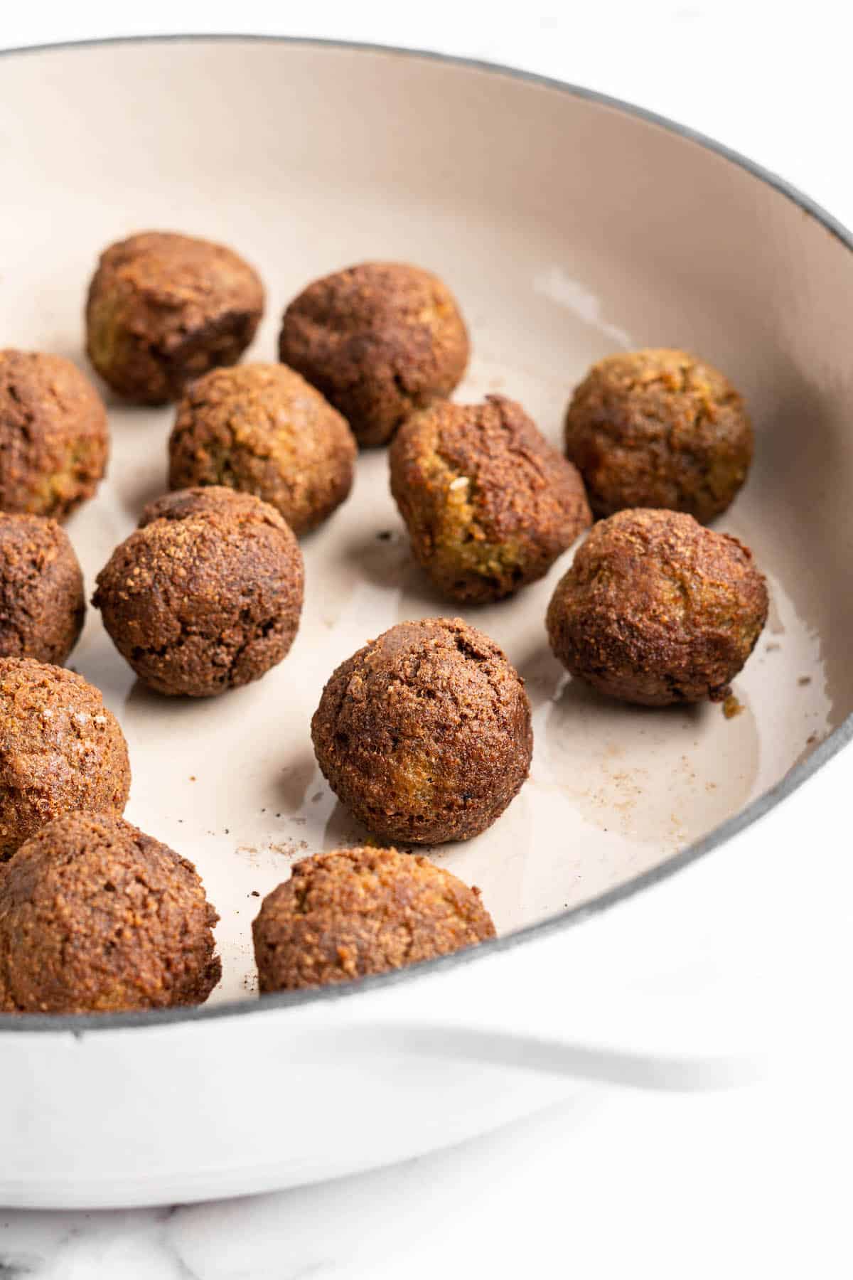 Vegan meatballs cooking in pan