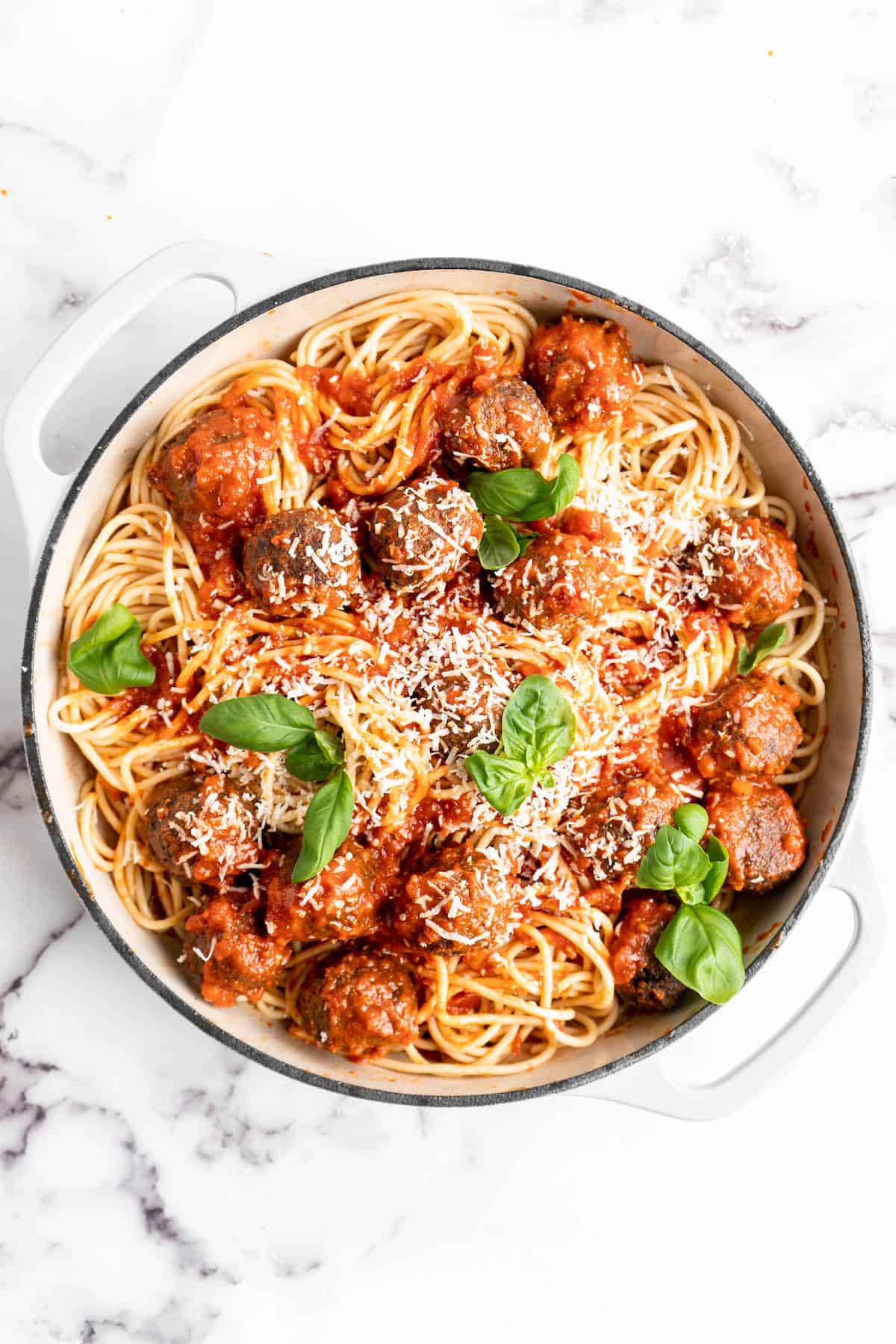 Pan of vegan spaghetti and meatballs with Parmesan and basil