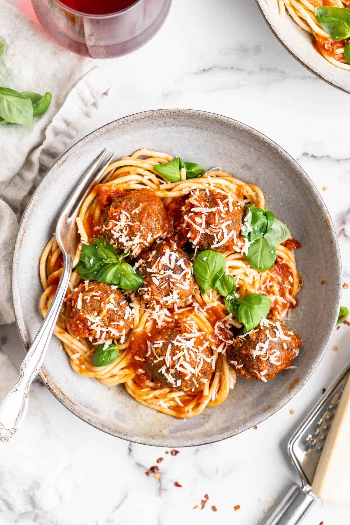 Overhead view of vegan spaghetti and meatballs on plate with fork