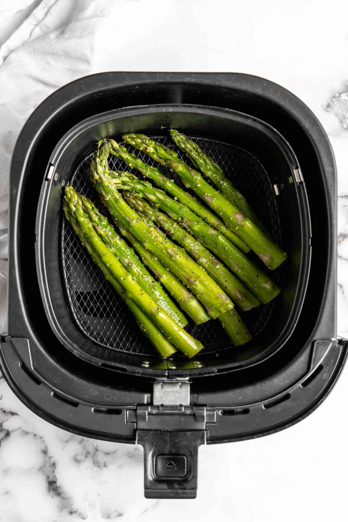 Overhead view of asparagus in air fryer