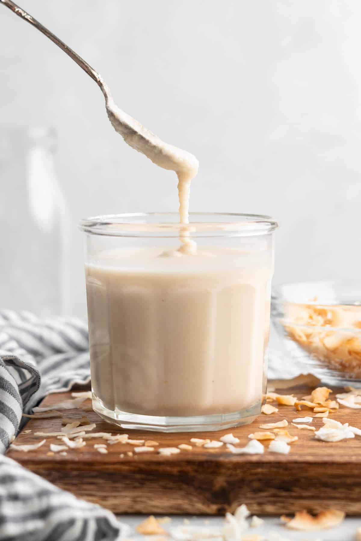 Spoon drizzling coconut butter into jar
