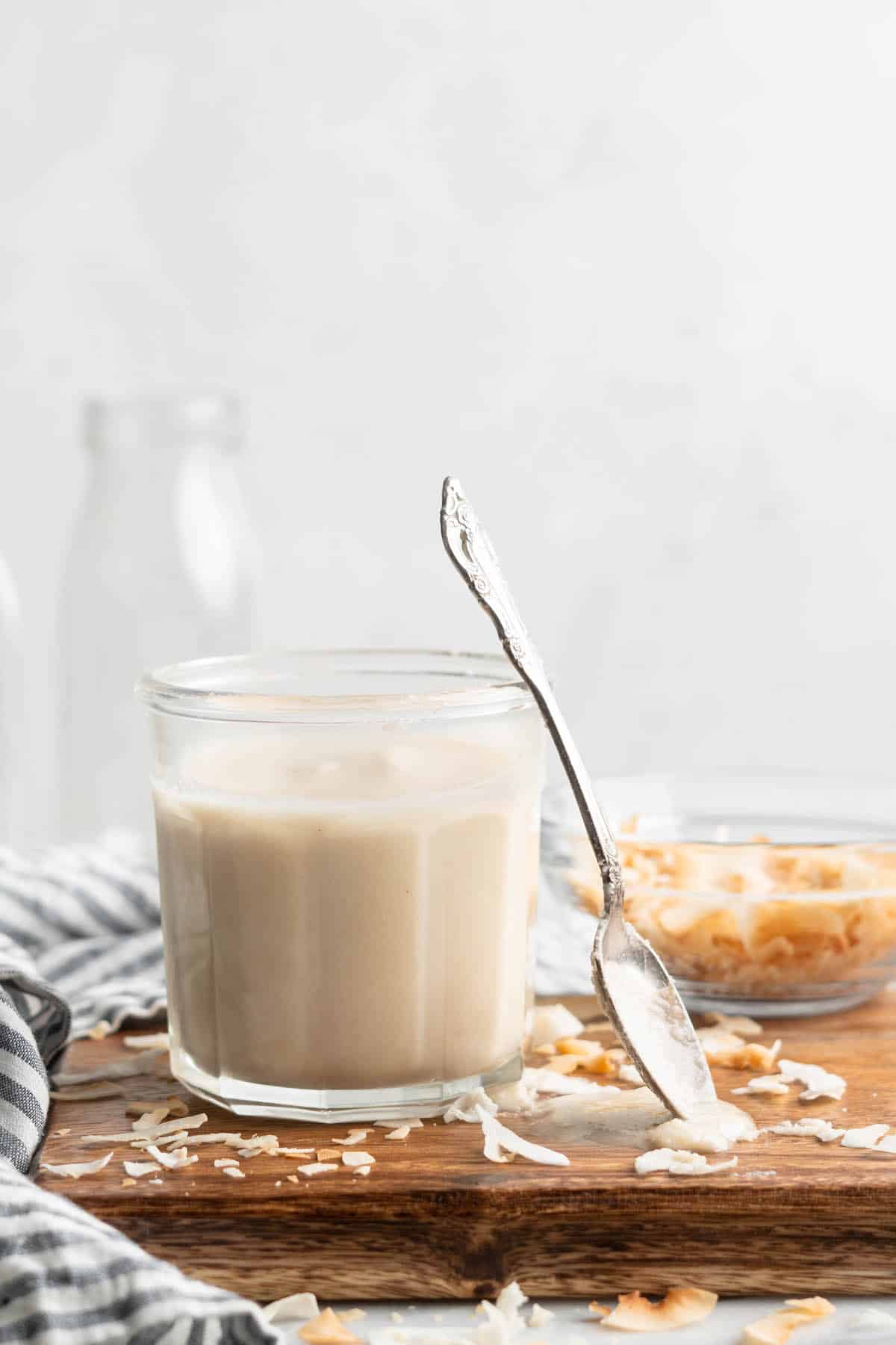 Coconut butter in jar with spoon next to it