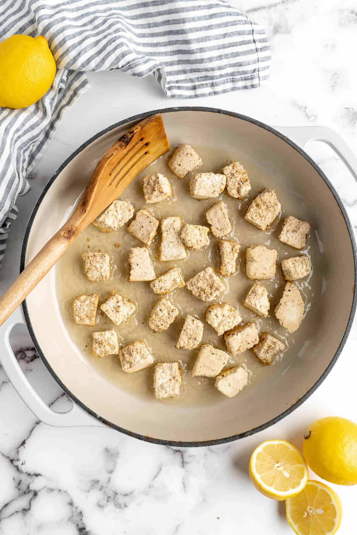 Overhead view of tofu and oil in skillet