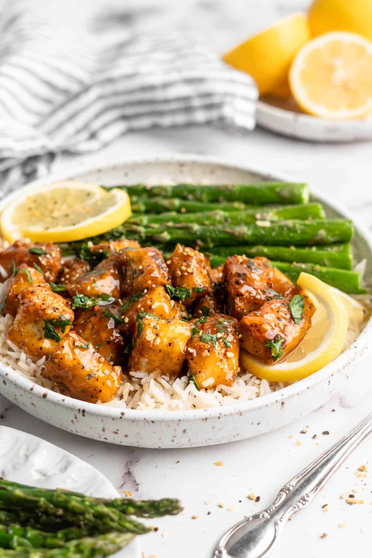 Plate of lemon pepper tofu with rice and asparagus