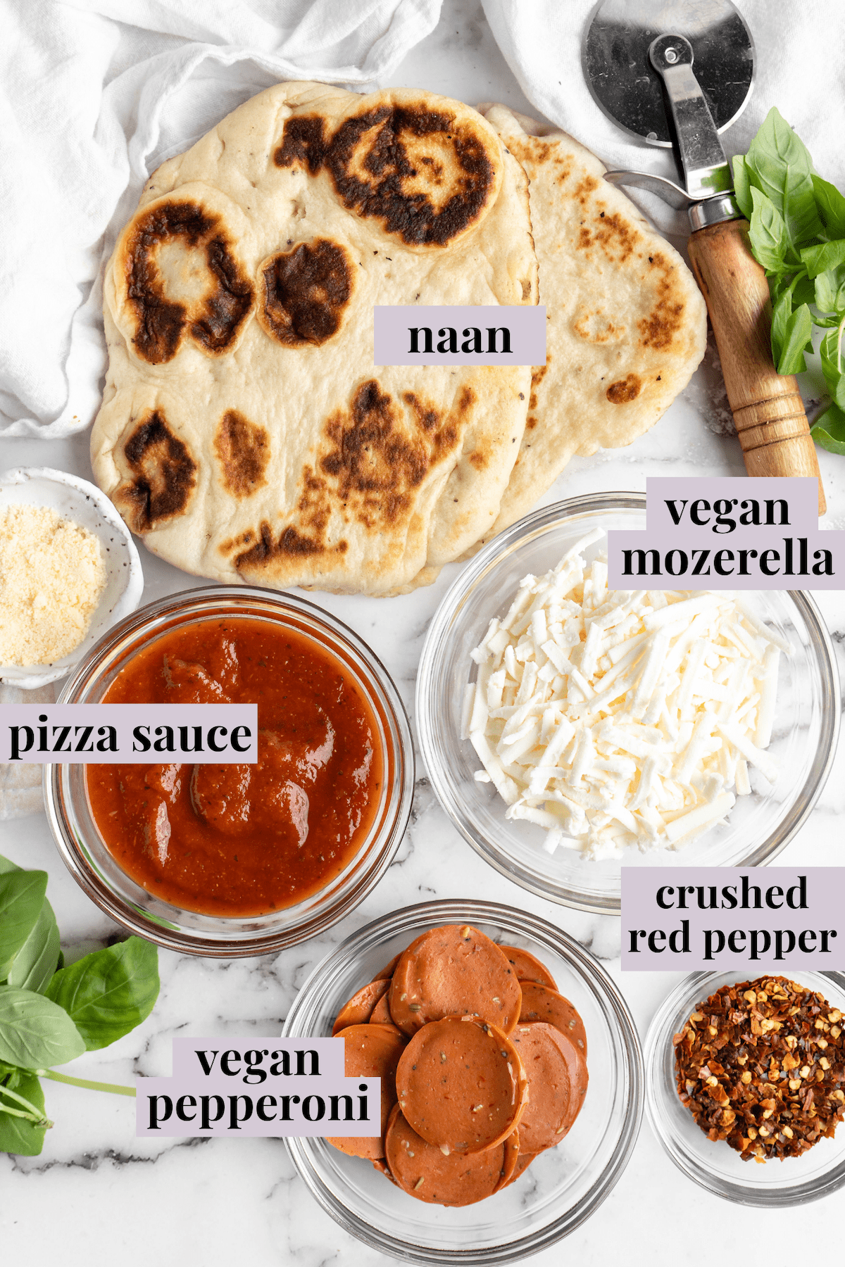 Overhead view of ingredients for vegan naan pizza with labels