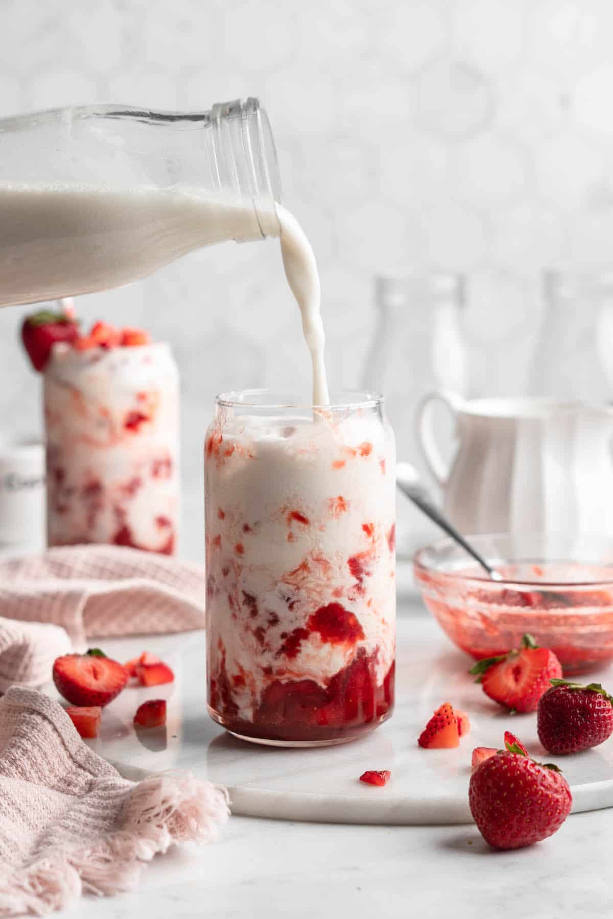 Pouring milk into glass of Korean strawberry milk