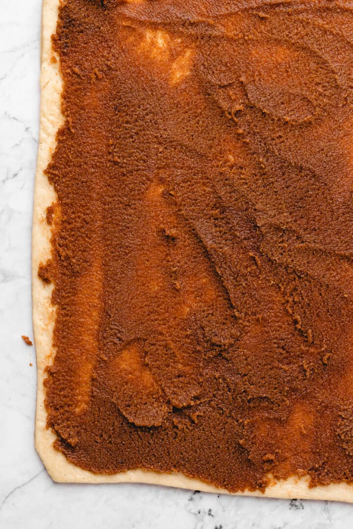 Overhead view of cinnamon filling spread on dough