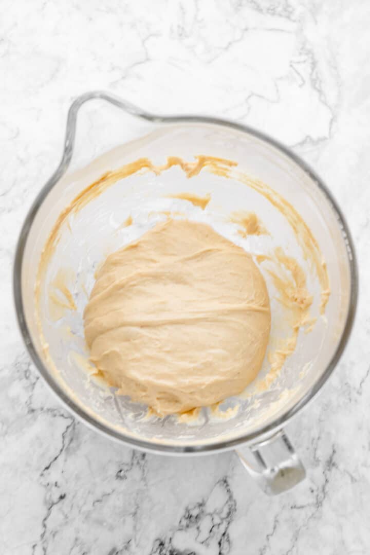 Overhead view of cinnamon roll dough in mixing bowl