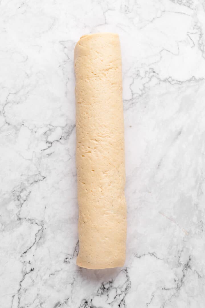 Overhead view of cinnamon roll dough log