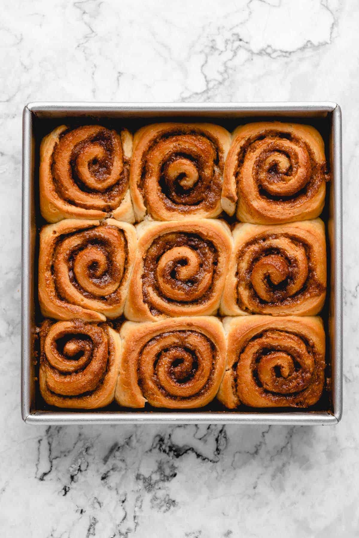 Overhead view of unfrosted cinnamon rolls in pan