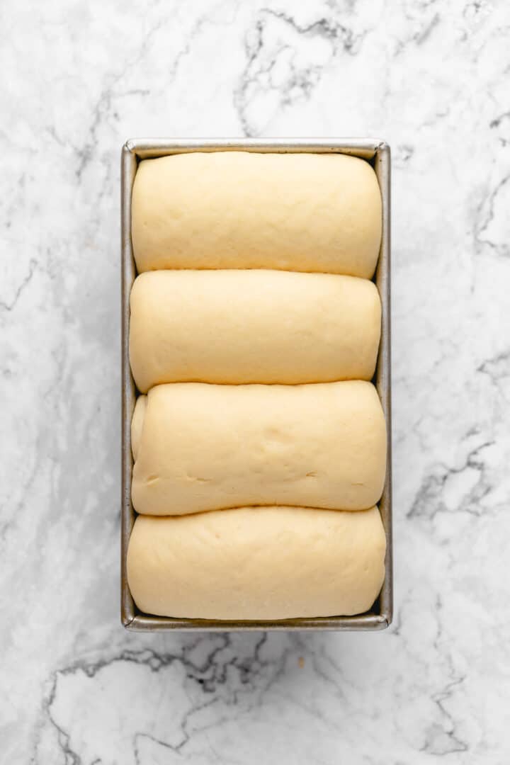 Overhead view of milk bread dough in loaf pan
