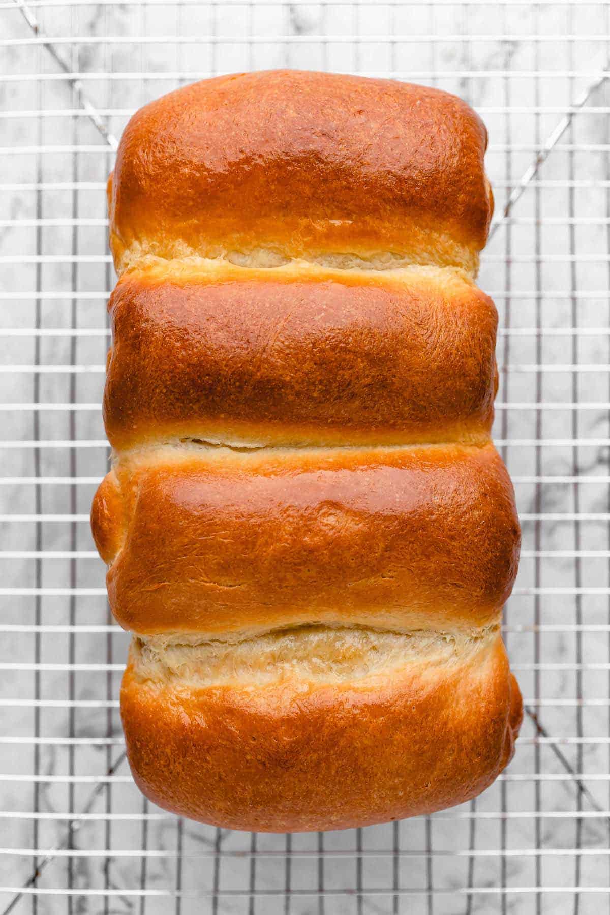 Overhead view of vegan milk bread on cooling rack