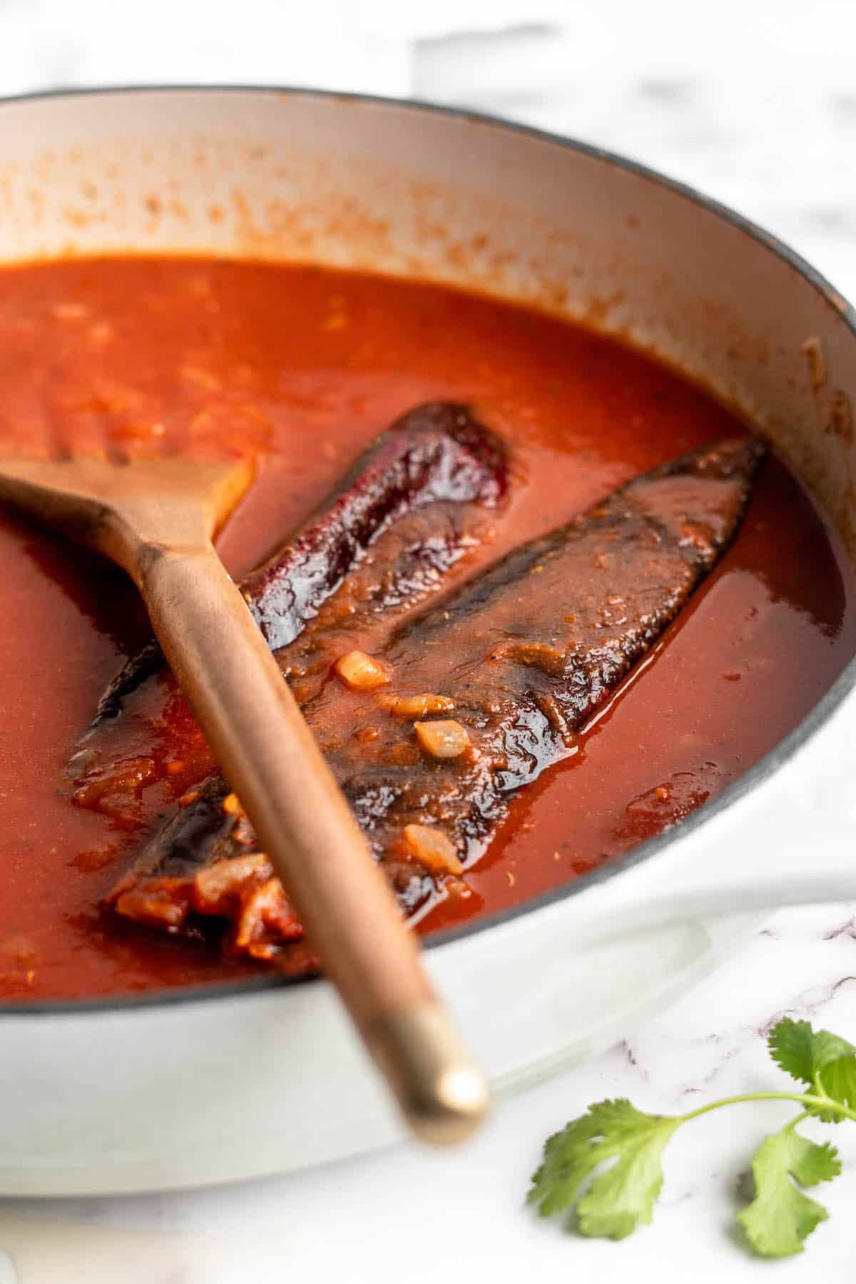 Birria sauce simmering with guajillo chiles