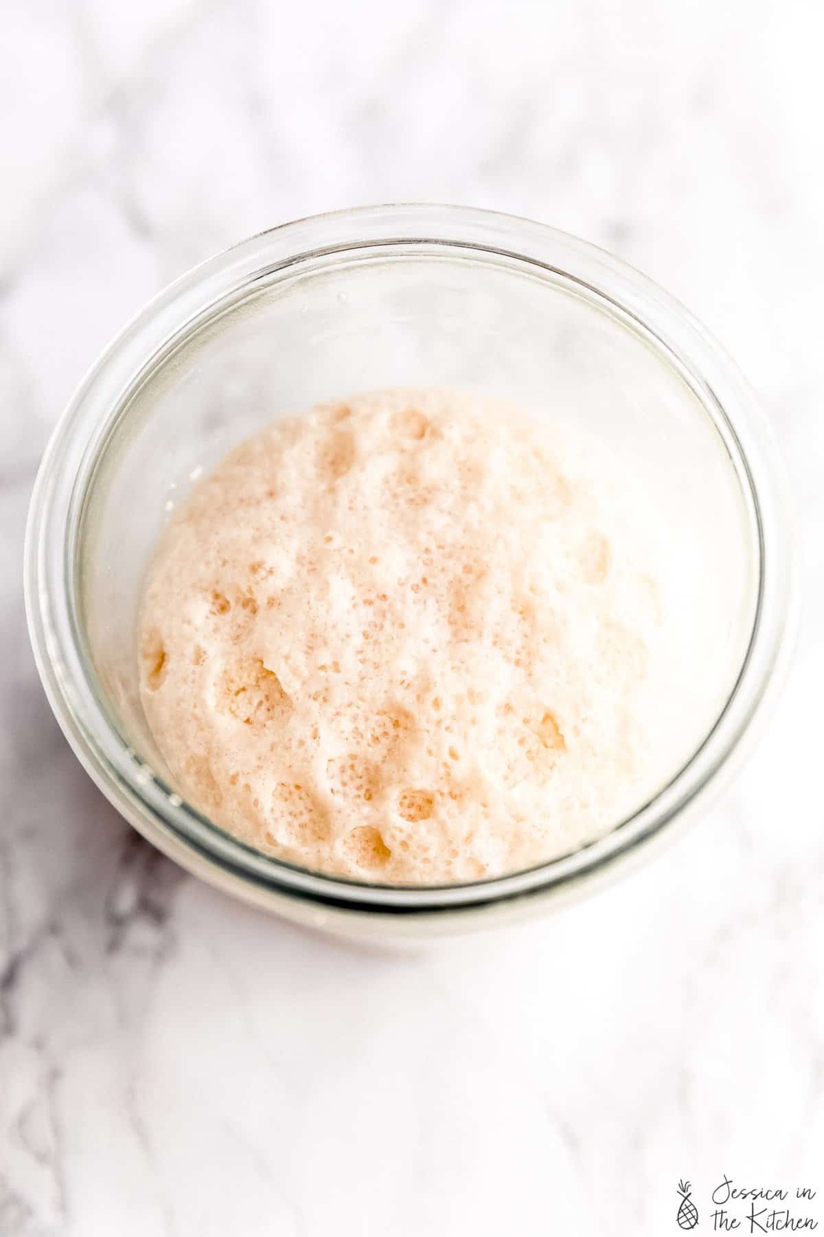 A bowl of yeast foaming in water