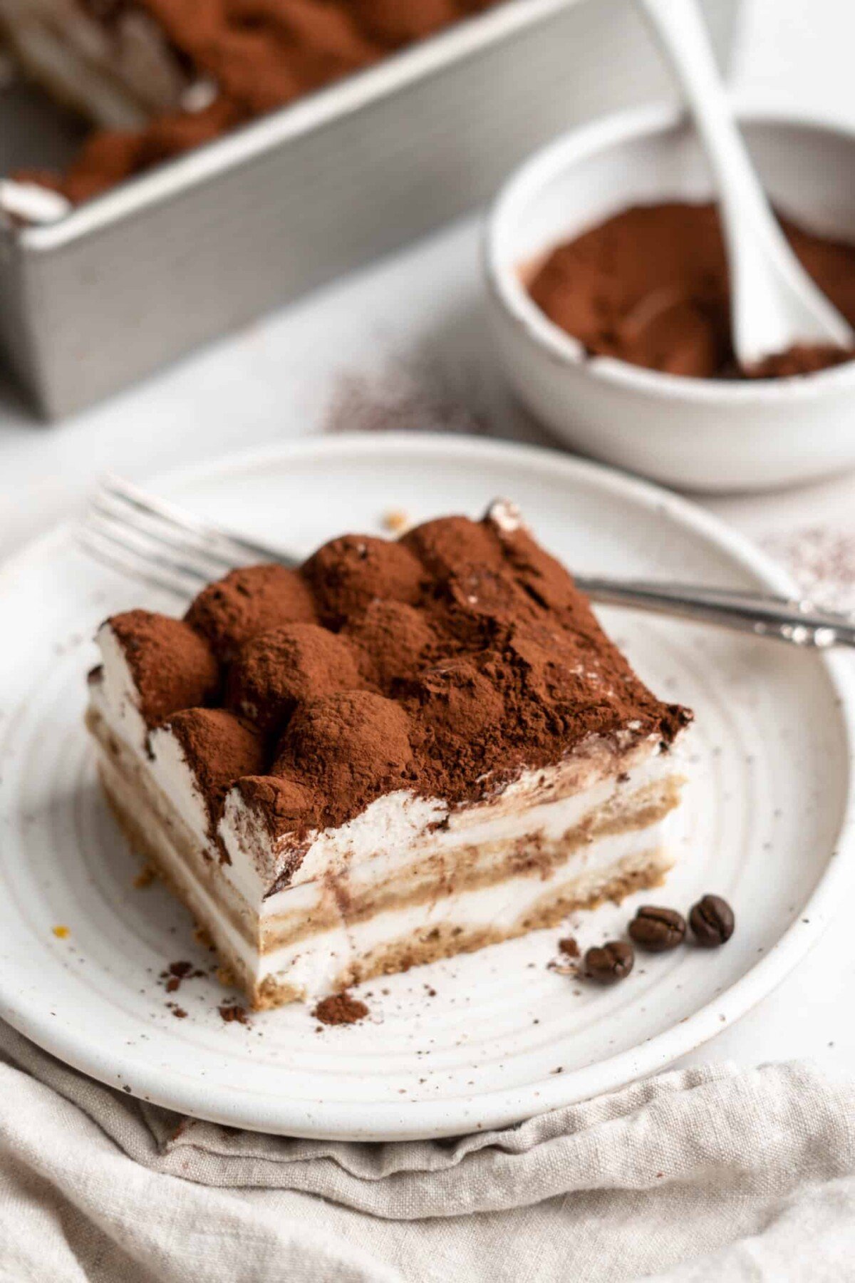 A slice of tiramisu on a plate with a fork