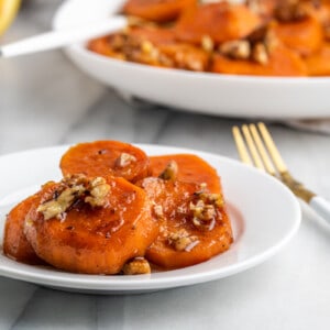 A plate a candied yams with a fork