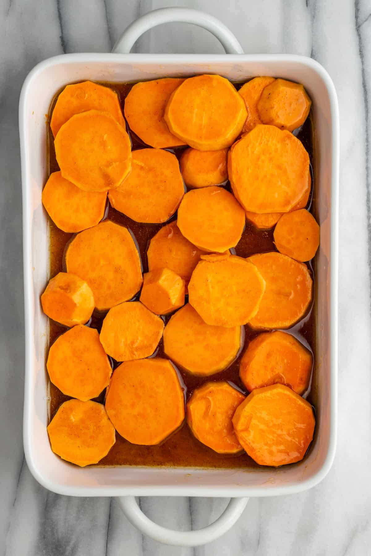 Uncooked yams in a baking tray