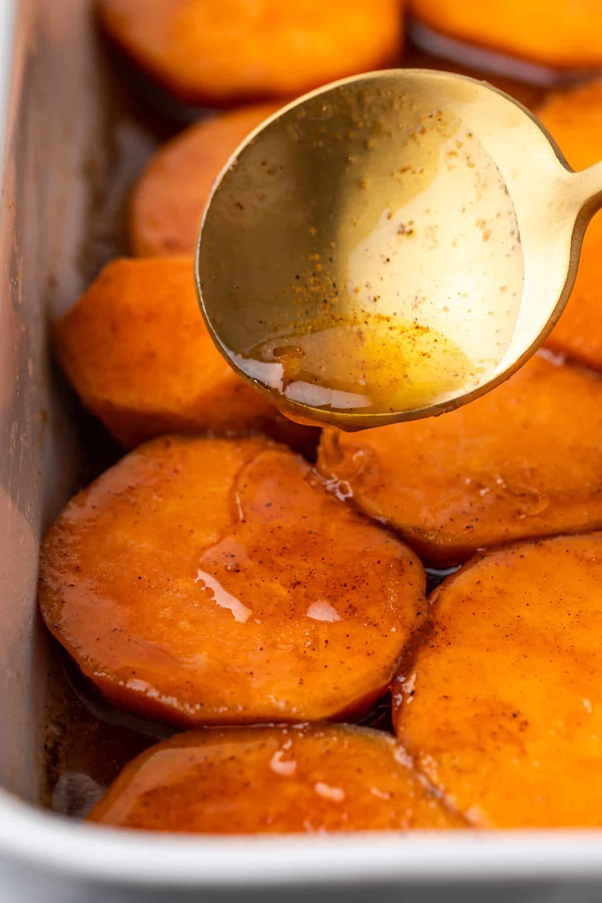 Spooning sauce on candied yams