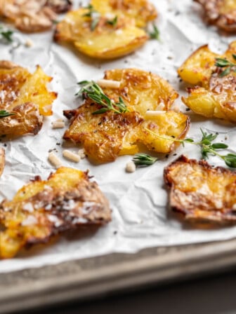Crispy smashed potatoes topped with herbs