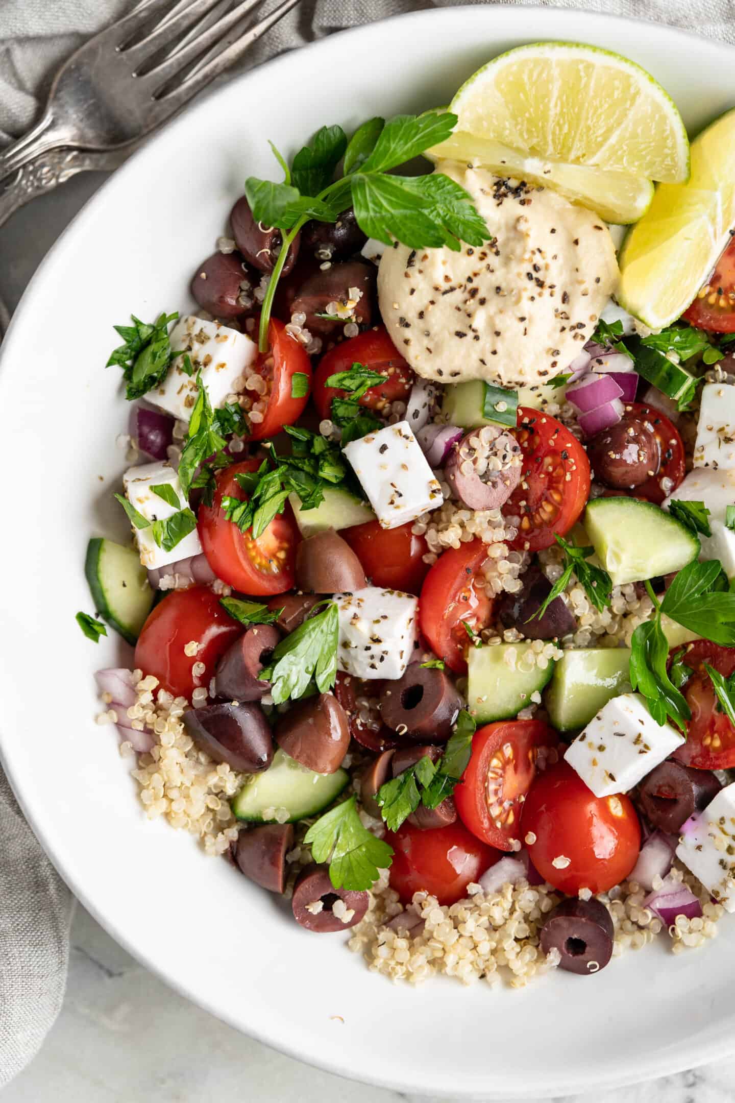 A bowl of cucumber salad with quinoa