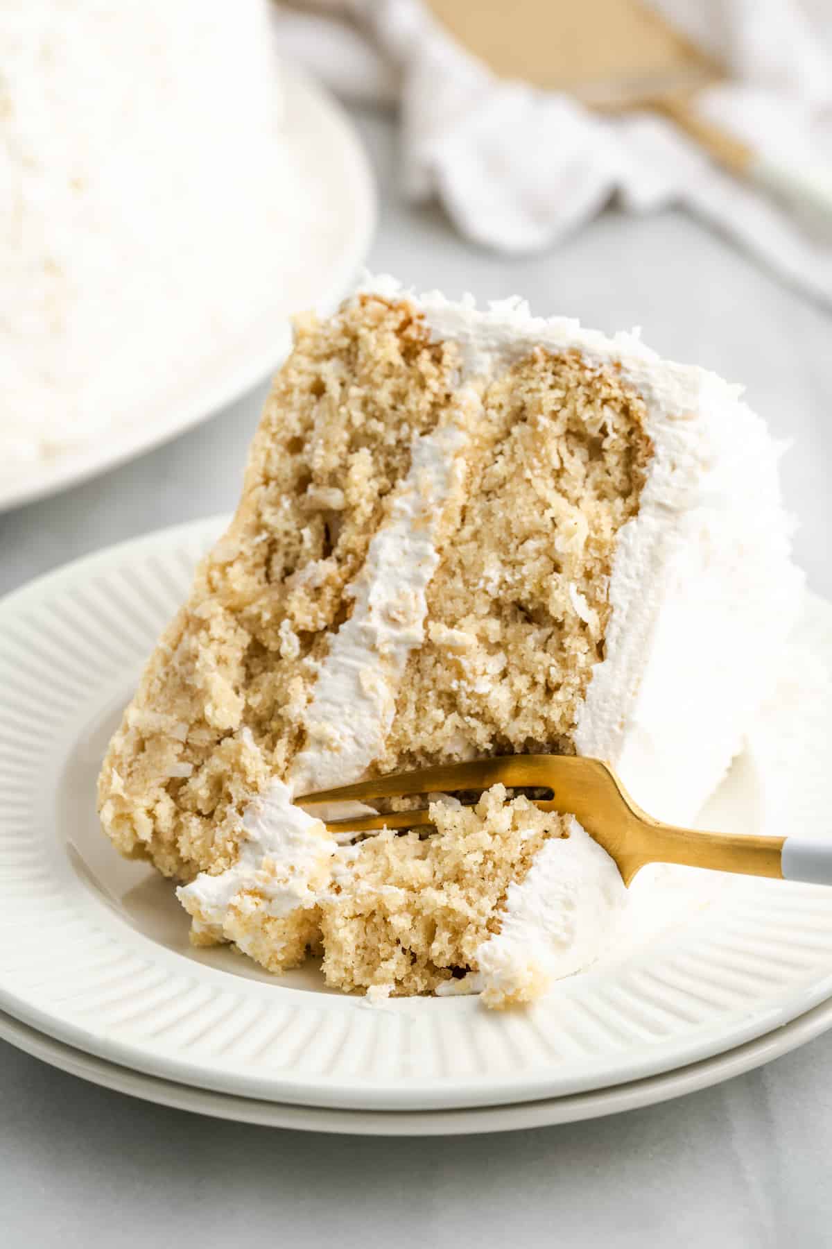 slice of vegan coconut cake with a fork in it