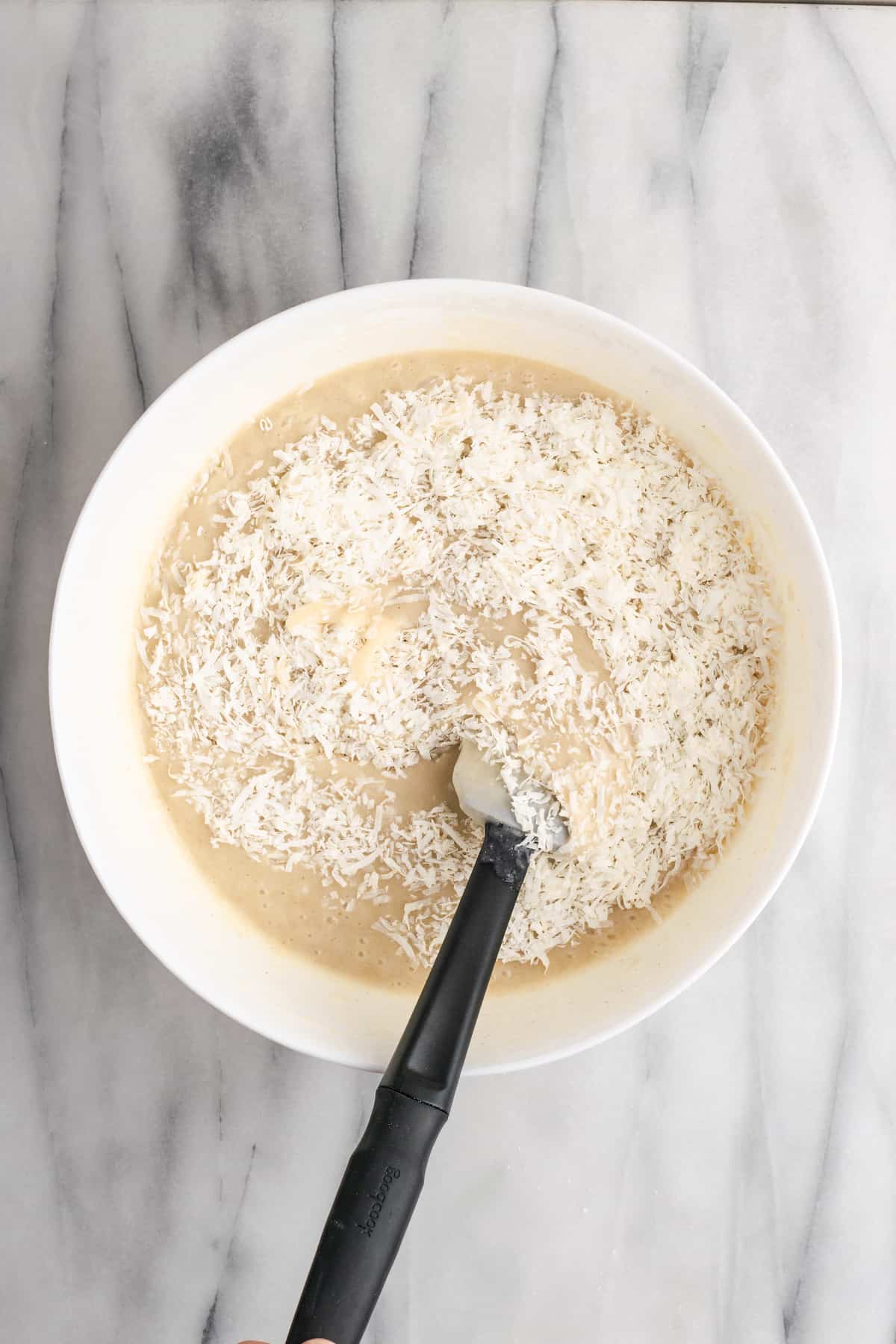 mixing batter for vegan coconut cake