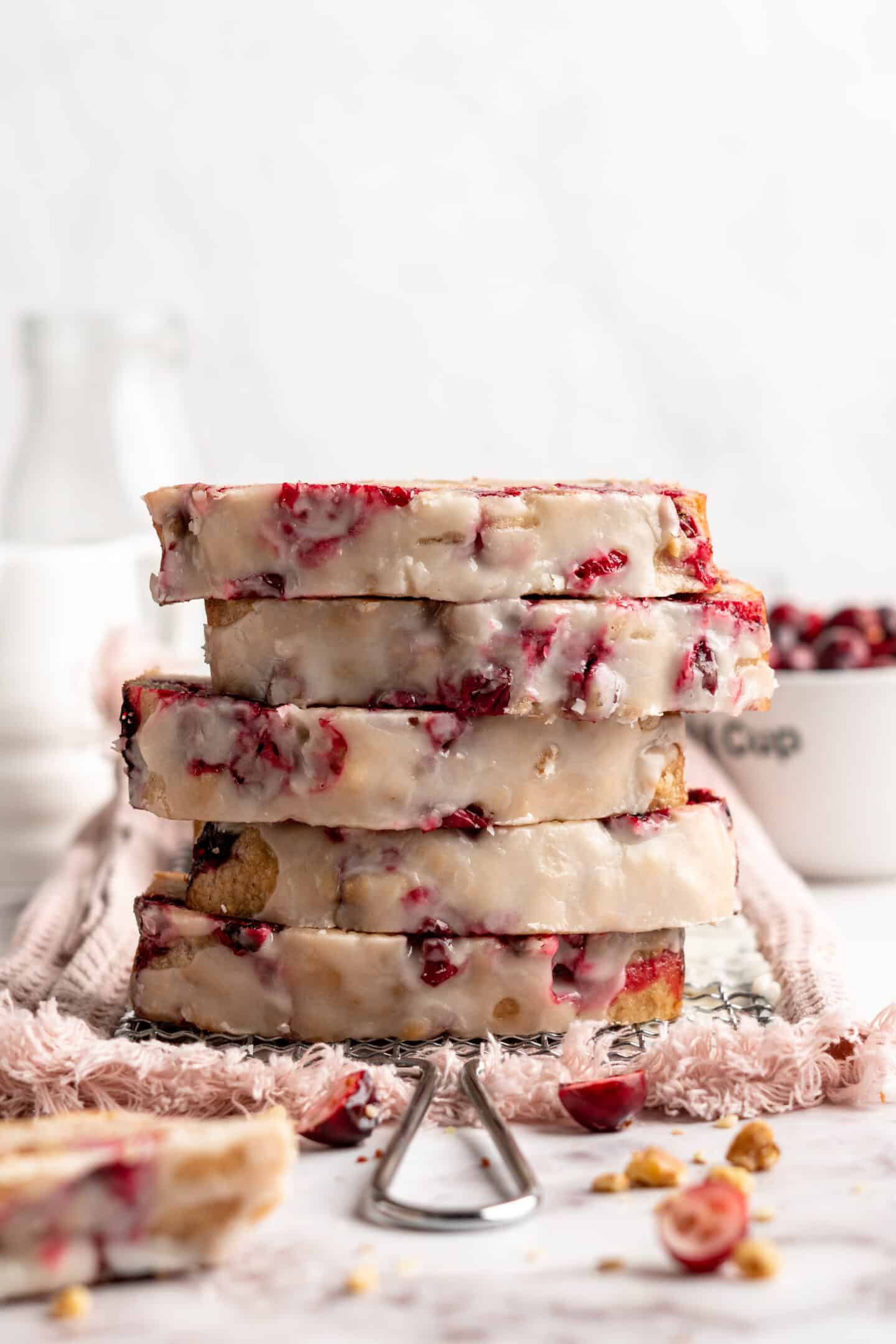 Five pieces of cranberry orange bread stacked on top of each other