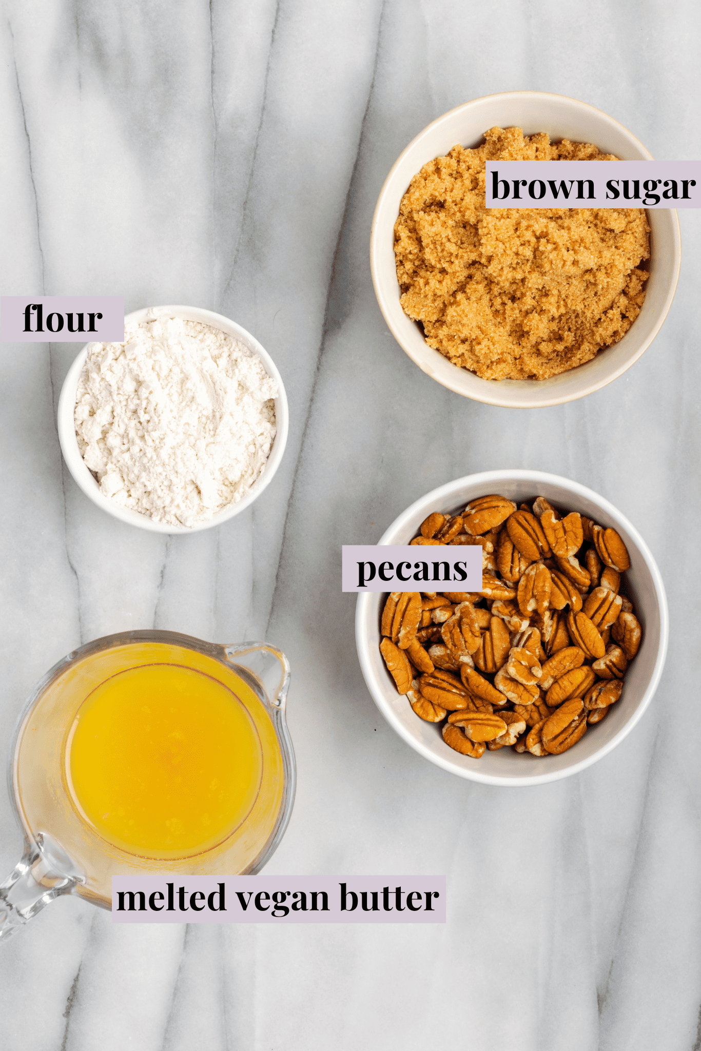 Overhead view of the ingredients for sweet potato soufflé: a bowl of brown sugar, flour, pecans and melted vegan butter